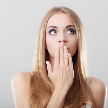 Embarrassed Woman Covering Her Mouth
